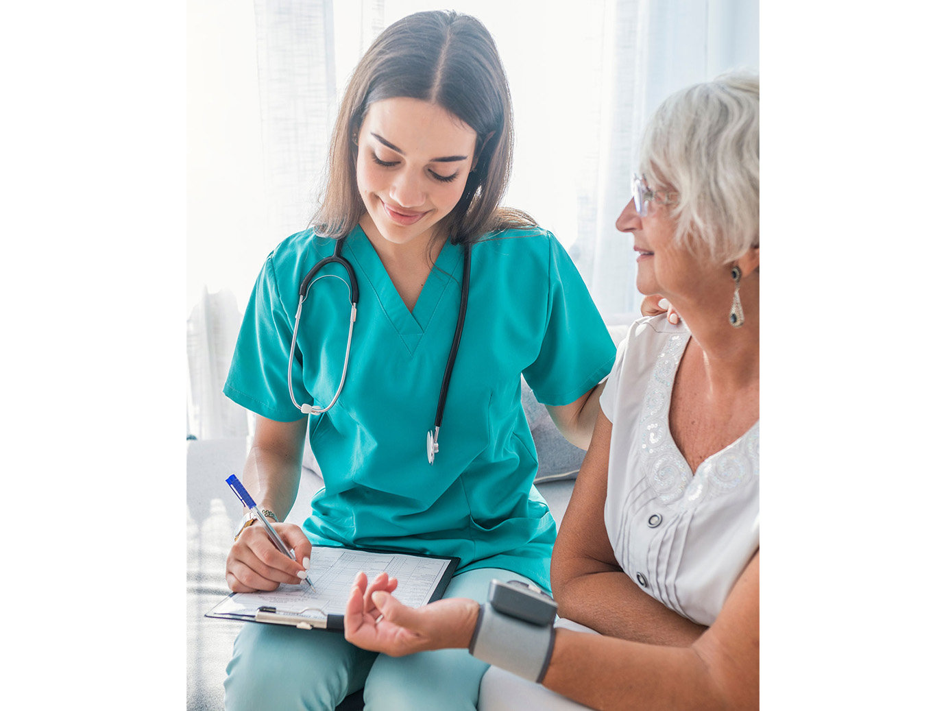 A healthcare professional at work with an elderly patient