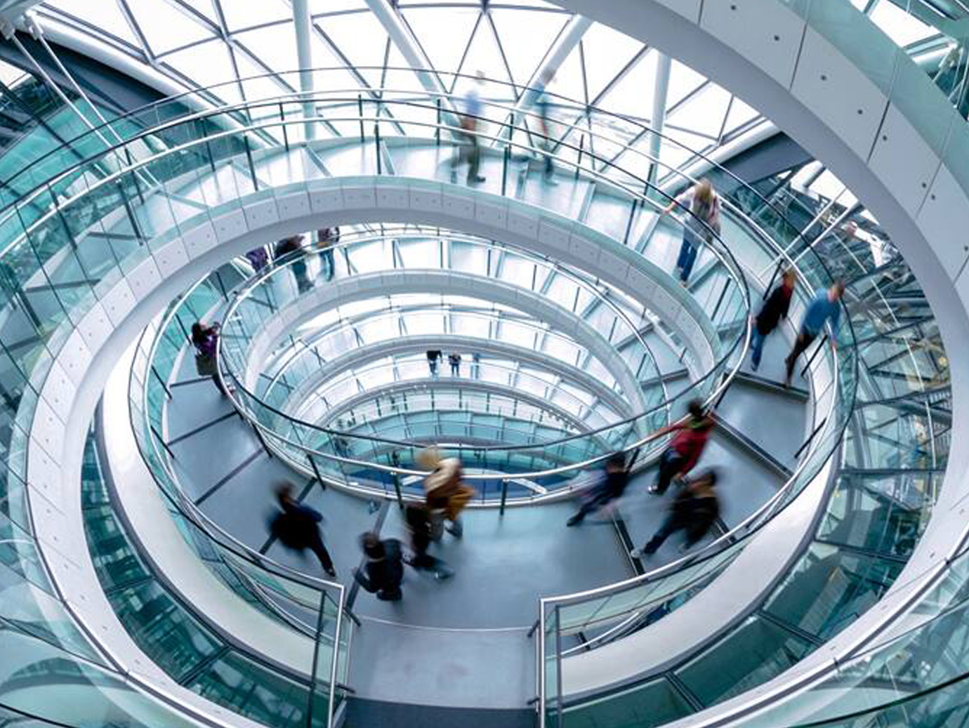 Motion blur picture of people walking down the spiral stairs
