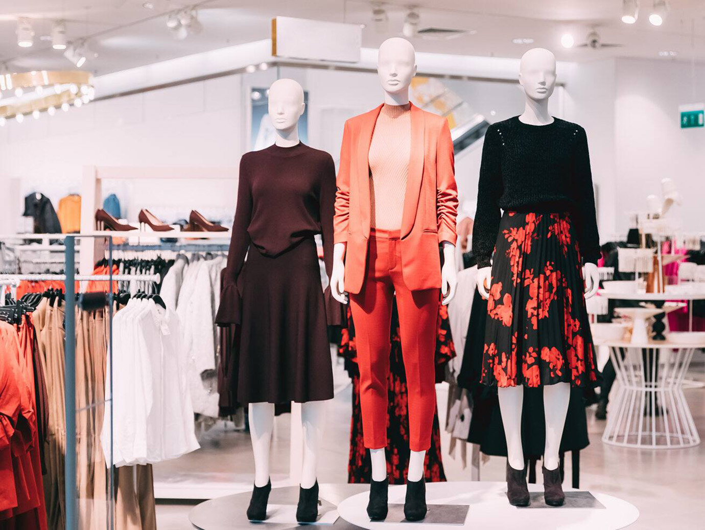 Interior view of a clothing store with three mannequins