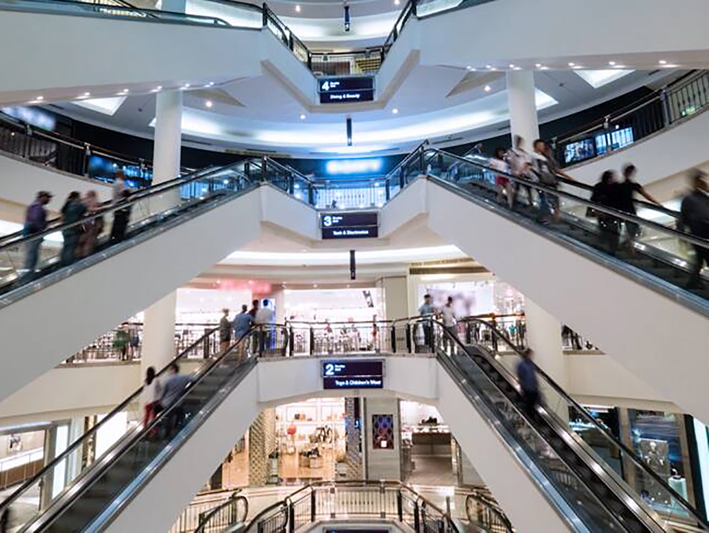 View of a mall's interior with motion blur picture of people on escalator