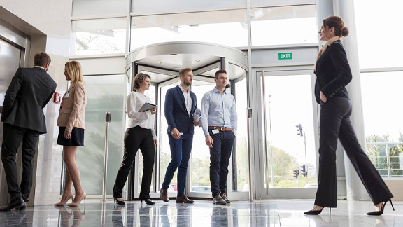 View of employees coming in to the office at the entrance of the building